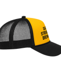 A black and yellow trucker hat with a yellow front panel and black mesh back, featuring the text 'DAD'S STRENGTH BREWING' in black on the yellow panel.