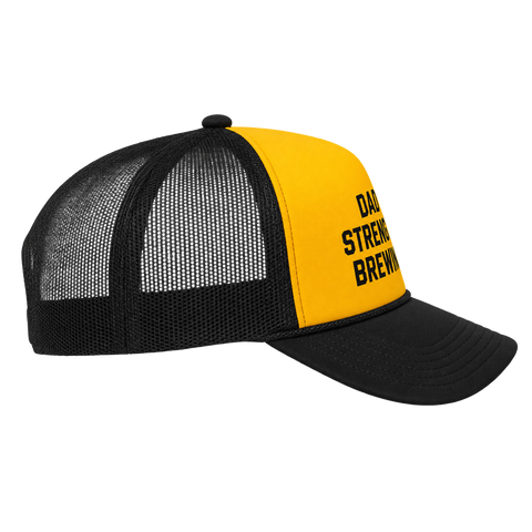 A black and yellow trucker hat with a yellow front panel and black mesh back, featuring the text 'DAD'S STRENGTH BREWING' in black on the yellow panel.